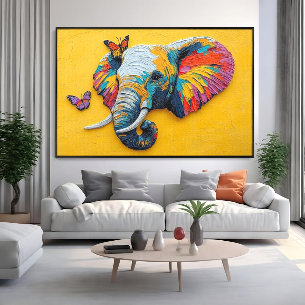 Tablou canvas cu tablou canvas cu elefant colorat si fluturi, in rama de aluminiu negru, pe perete intr-un living